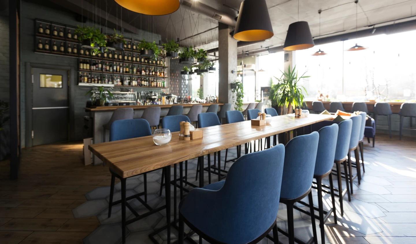 Finished restaurant interior with industrial dining bar built by Go To Guys RGV